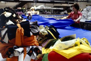 Lady seamstress stitching Admiral football shirts in the 1970s in a factory